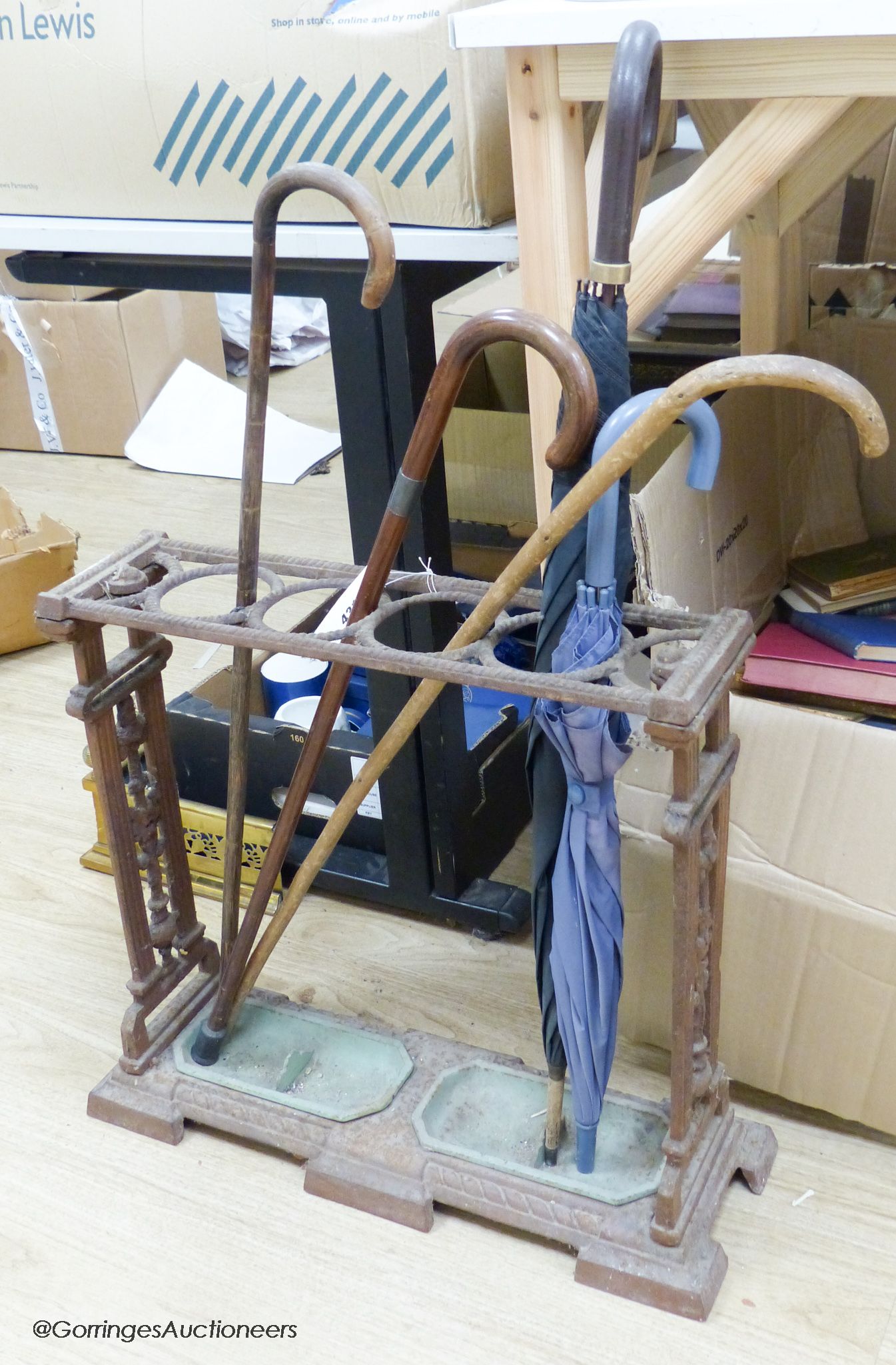 A Victorian cast iron stickstand and 5 sticks/umbrellas